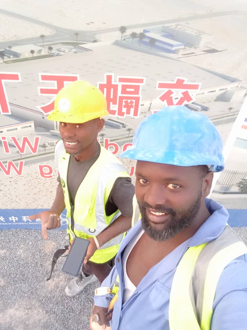 Two workers smiling on a construction site